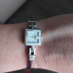 Gucci watch with mother of pearl face + thin brown leather strap